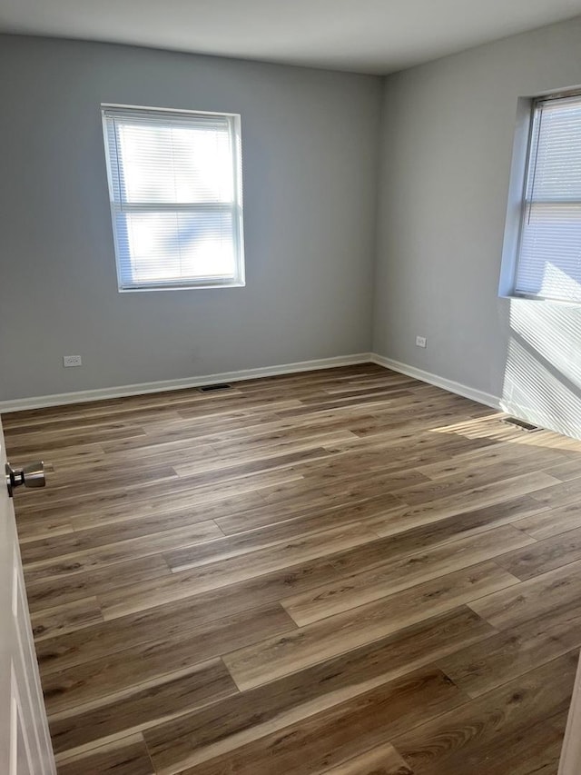 spare room with dark wood-type flooring