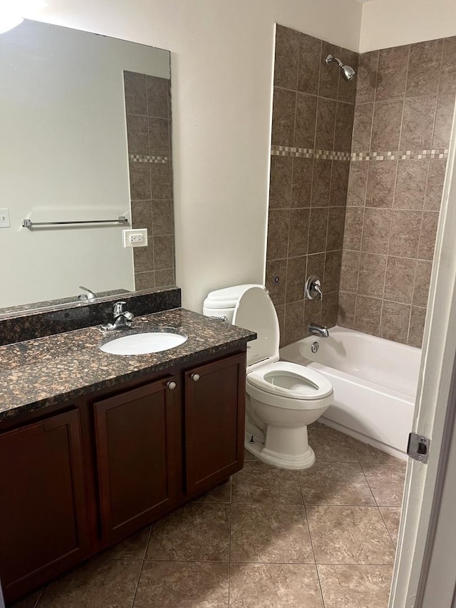 full bathroom with vanity, tile patterned flooring, toilet, and tiled shower / bath