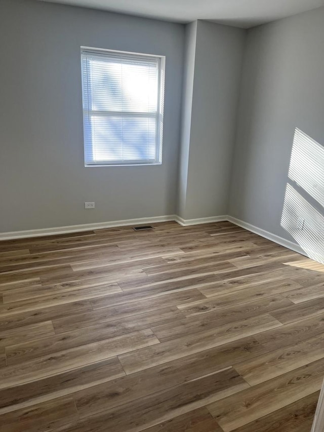 empty room featuring hardwood / wood-style flooring