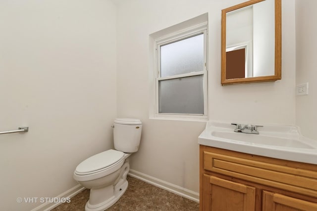 bathroom featuring vanity, tile patterned floors, and toilet