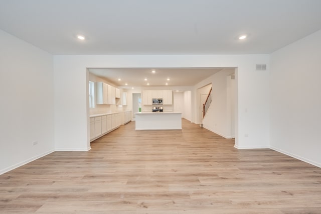 unfurnished living room featuring light hardwood / wood-style floors