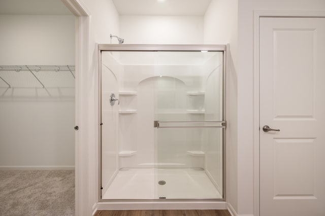 bathroom featuring a shower with shower door