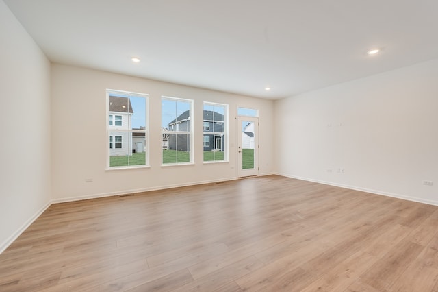 spare room featuring light wood-type flooring