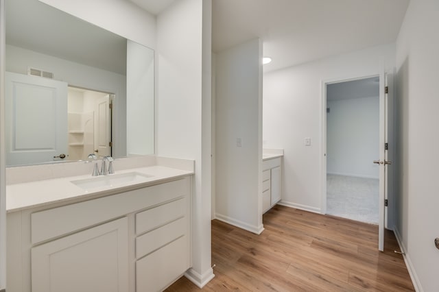 bathroom with vanity and hardwood / wood-style floors