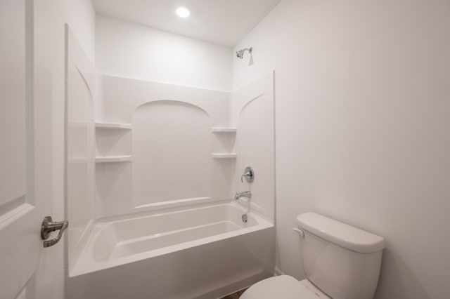 bathroom featuring bathtub / shower combination and toilet