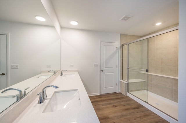 bathroom featuring walk in shower, vanity, and hardwood / wood-style floors