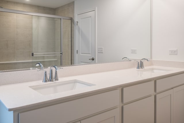 bathroom featuring vanity and a shower with shower door