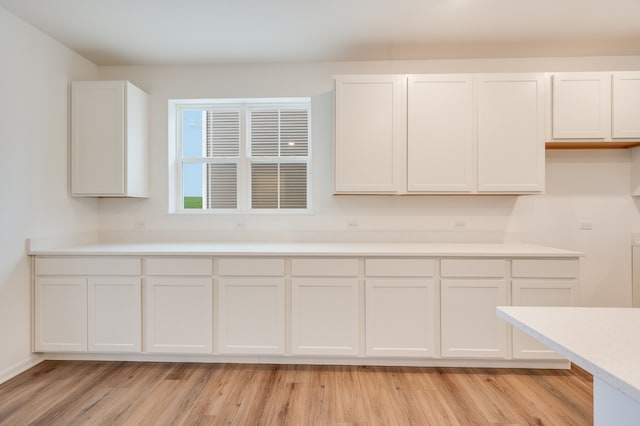 kitchen featuring white cabinetry and light hardwood / wood-style floors