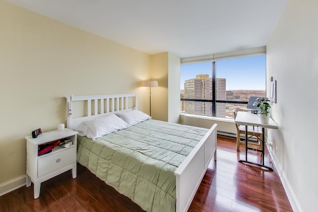 bedroom with dark wood-type flooring