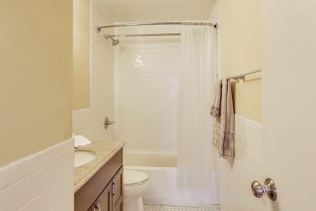 full bathroom featuring tile walls, tile patterned flooring, vanity, toilet, and shower / bathtub combination with curtain