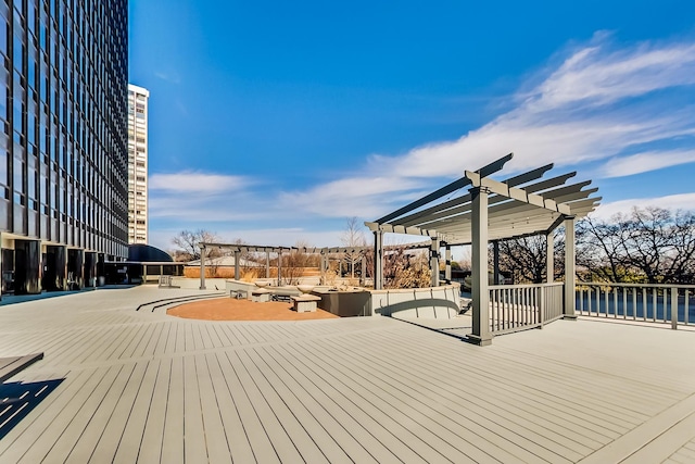 wooden terrace with a pergola and a patio