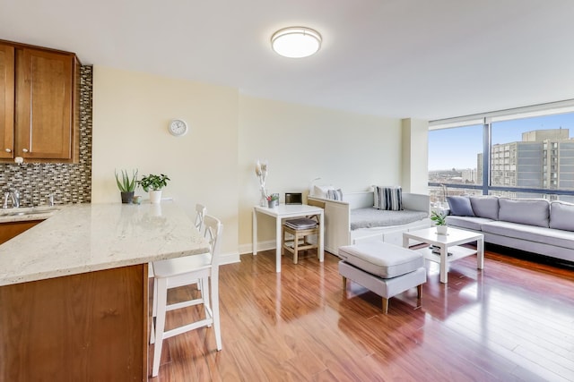 living room with sink and light hardwood / wood-style floors