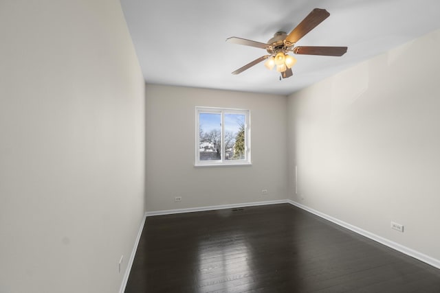 spare room with dark hardwood / wood-style floors and ceiling fan