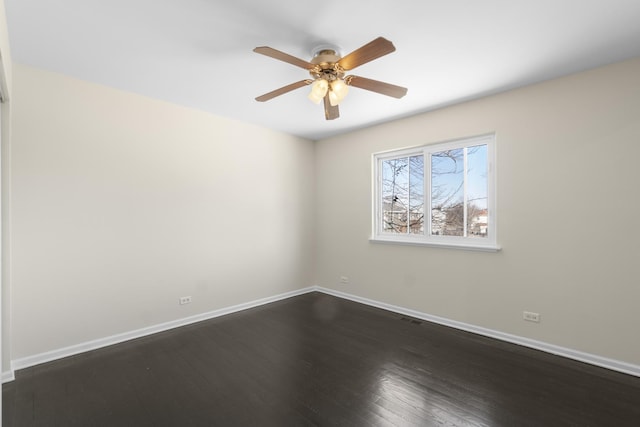 empty room featuring dark wood-type flooring and ceiling fan