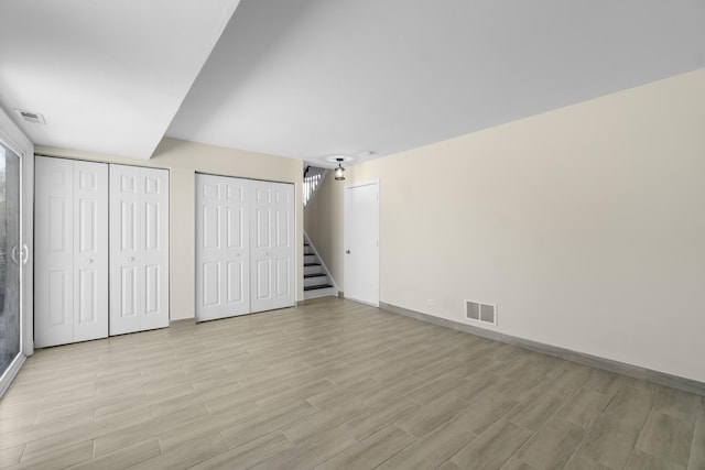 unfurnished bedroom featuring two closets