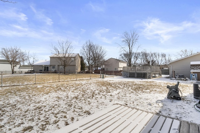 yard covered in snow with a trampoline