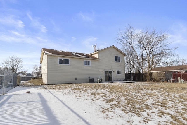 snow covered house with central AC