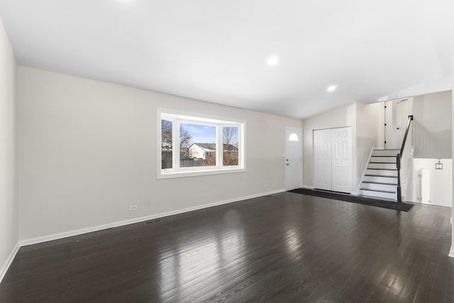 interior space with dark hardwood / wood-style flooring and lofted ceiling