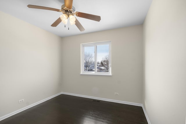 empty room with dark hardwood / wood-style floors and ceiling fan