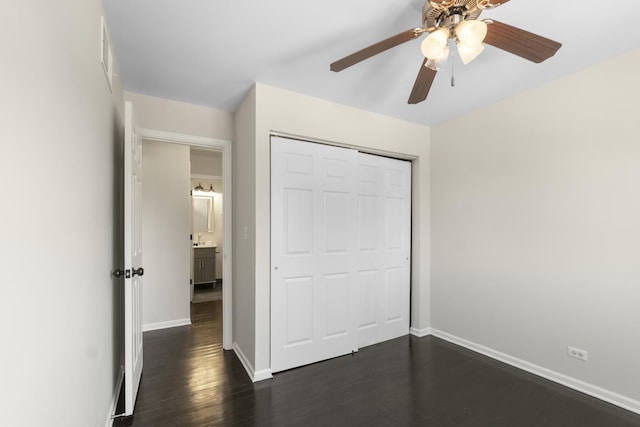 unfurnished bedroom featuring dark hardwood / wood-style floors, a closet, and ceiling fan