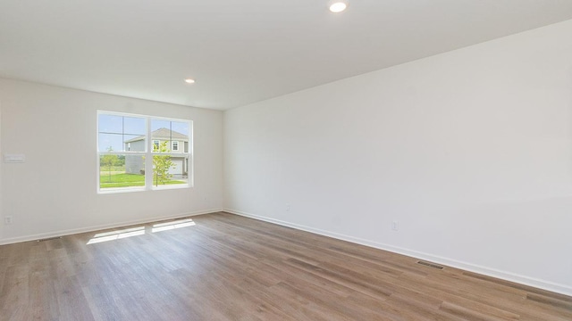 unfurnished room with light hardwood / wood-style flooring