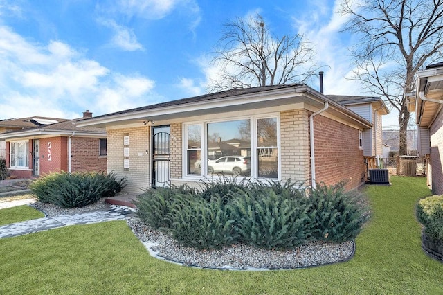 ranch-style home featuring central AC unit and a front lawn