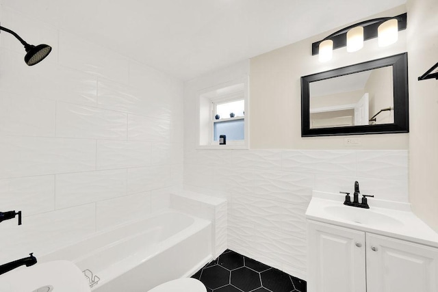 bathroom featuring tile patterned floors, toilet, sink, and tile walls