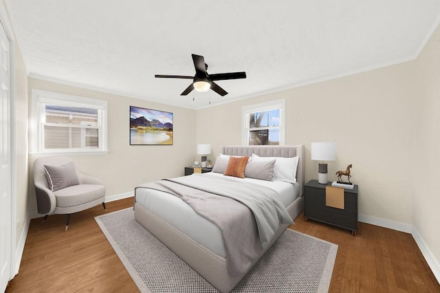 bedroom featuring crown molding, hardwood / wood-style flooring, and ceiling fan