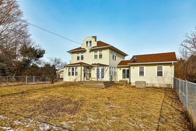 back of house with a lawn