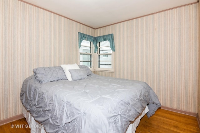 bedroom featuring hardwood / wood-style flooring and crown molding