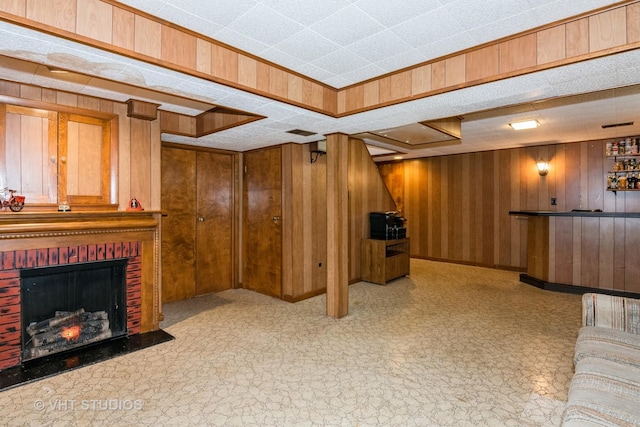 living room with indoor bar, a brick fireplace, and wood walls