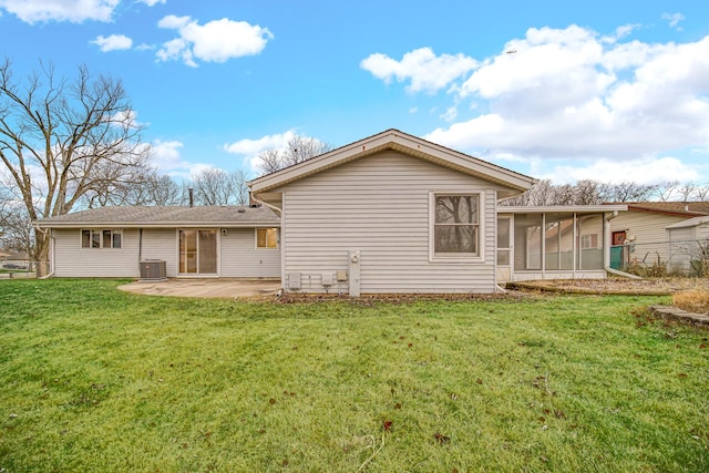 rear view of house featuring a yard, a sunroom, a patio, and central air condition unit