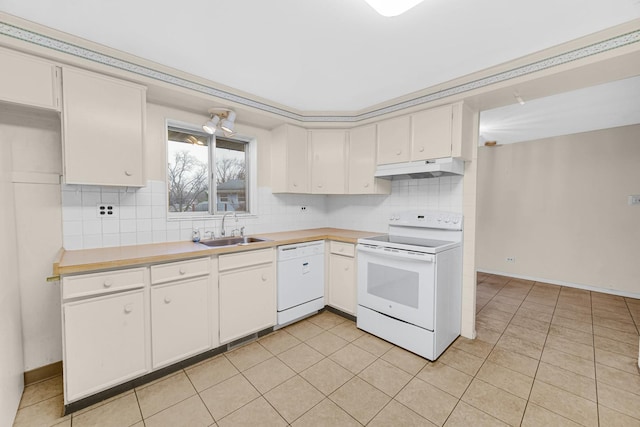 kitchen with sink, white appliances, light tile patterned floors, tasteful backsplash, and white cabinets