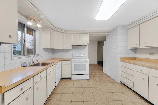 kitchen with sink, light tile patterned floors, white range with electric stovetop, decorative backsplash, and white cabinets