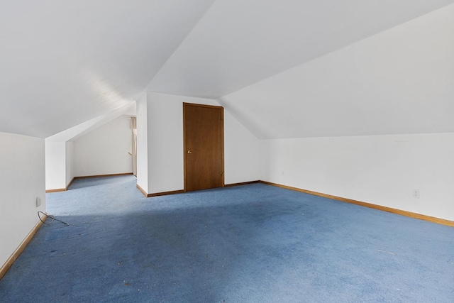 bonus room with lofted ceiling and carpet flooring