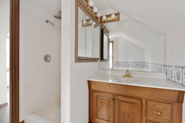 bathroom featuring vanity and vaulted ceiling