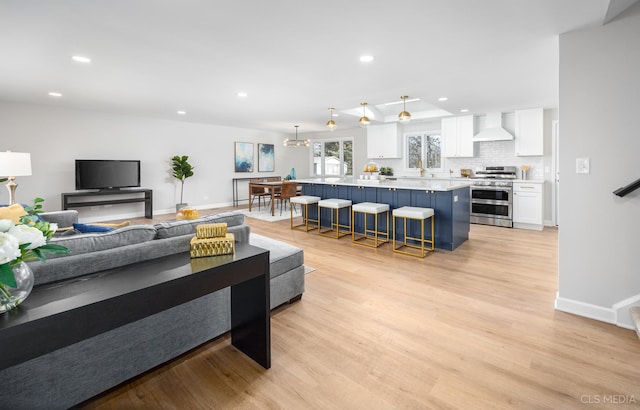 living room featuring a chandelier and light hardwood / wood-style flooring