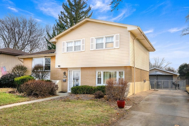 view of front of property featuring a garage and a front lawn