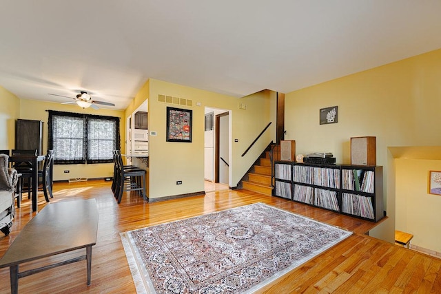 living room featuring hardwood / wood-style flooring and ceiling fan