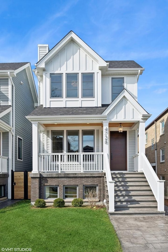 4728 N Hermitage Ave, Chicago, IL 60640 - view of front of home featuring a shingled roof, stairway, covered porch, a front lawn, and board and batten siding