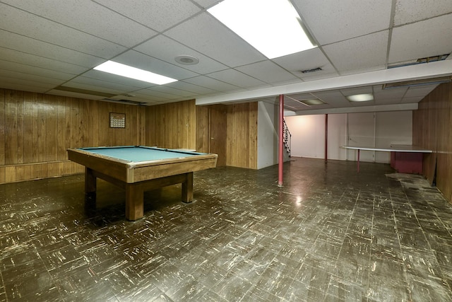 game room featuring billiards, a paneled ceiling, and wood walls