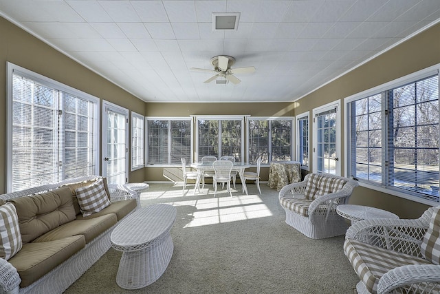 sunroom featuring ceiling fan and a healthy amount of sunlight