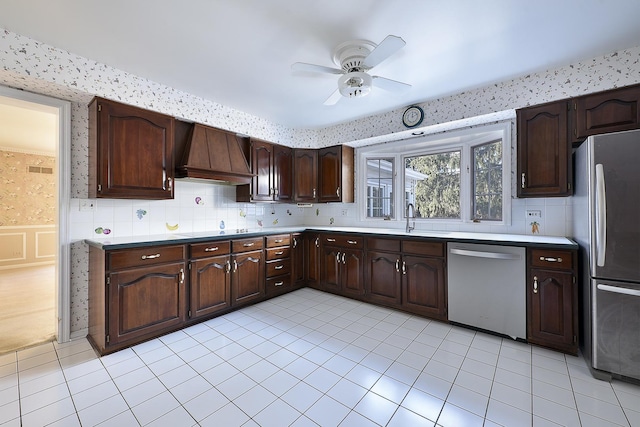 kitchen featuring light tile patterned flooring, appliances with stainless steel finishes, sink, dark brown cabinets, and custom range hood