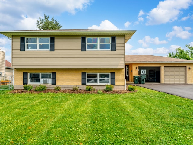 tri-level home featuring a garage and a front yard