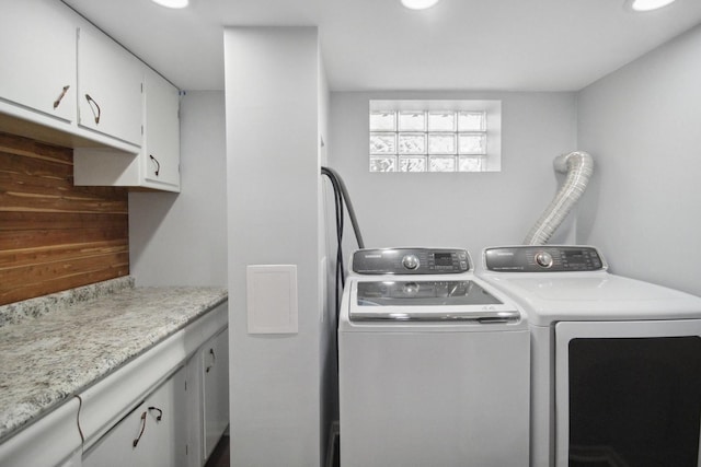 laundry room with cabinets and washer and clothes dryer