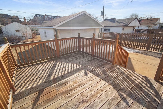 wooden deck featuring a garage and an outdoor structure