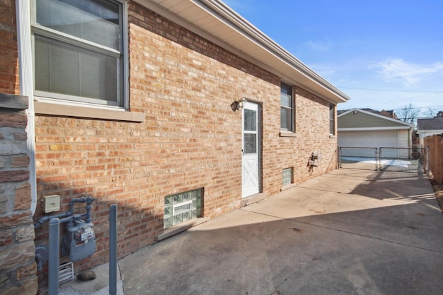 view of home's exterior with a garage and an outbuilding