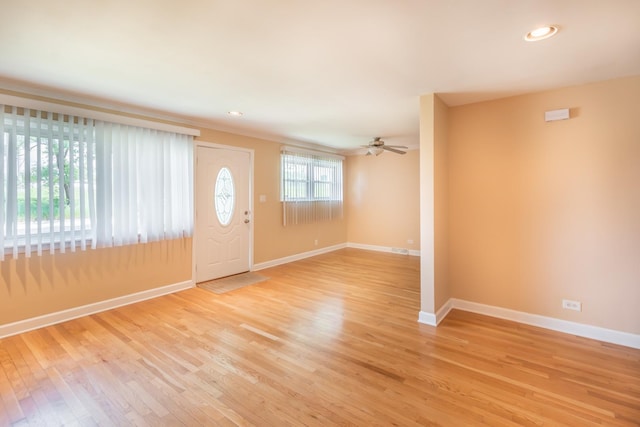 foyer with light hardwood / wood-style floors and ceiling fan