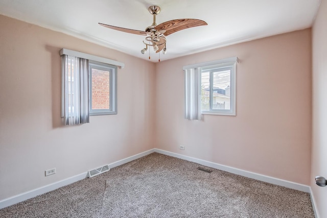 carpeted spare room with ceiling fan