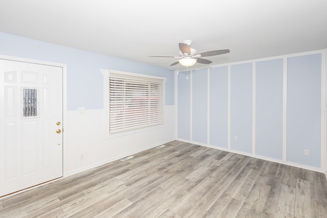 empty room with light hardwood / wood-style flooring and ceiling fan